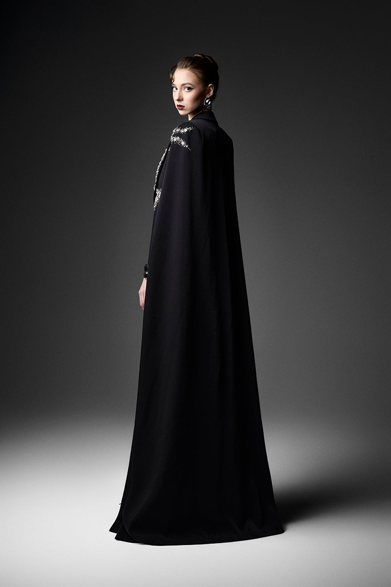 Black embroidered high-neck gown by GVLUX, featuring intricate embroidery and elegant design, displayed on a mannequin.