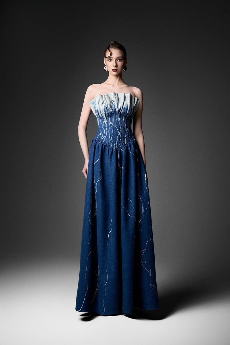 Elegant black strapless gown by GVLUX, featuring a flowing silhouette and sophisticated design for formal occasions.