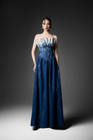 Elegant black strapless gown by GVLUX, featuring a flowing silhouette and sophisticated design for formal occasions.
