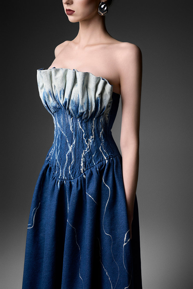 Elegant black strapless gown by GVLUX, featuring a flowing design and intricate details, perfect for formal occasions.