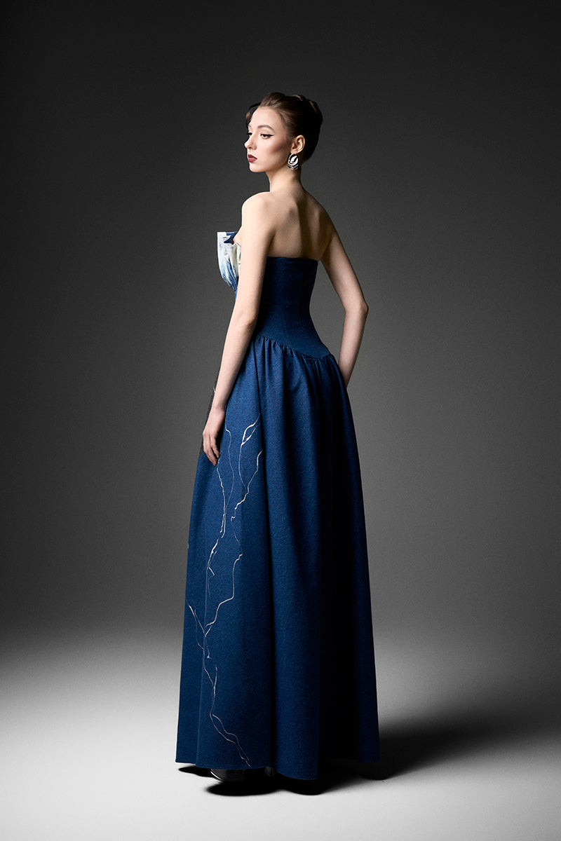 Elegant black strapless gown by GVLUX, featuring a flowing design and fitted bodice, perfect for formal occasions.