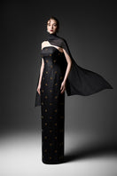 Black cape neck sweetheart gown by GVLUX, featuring elegant flowing fabric and a fitted bodice for formal occasions.