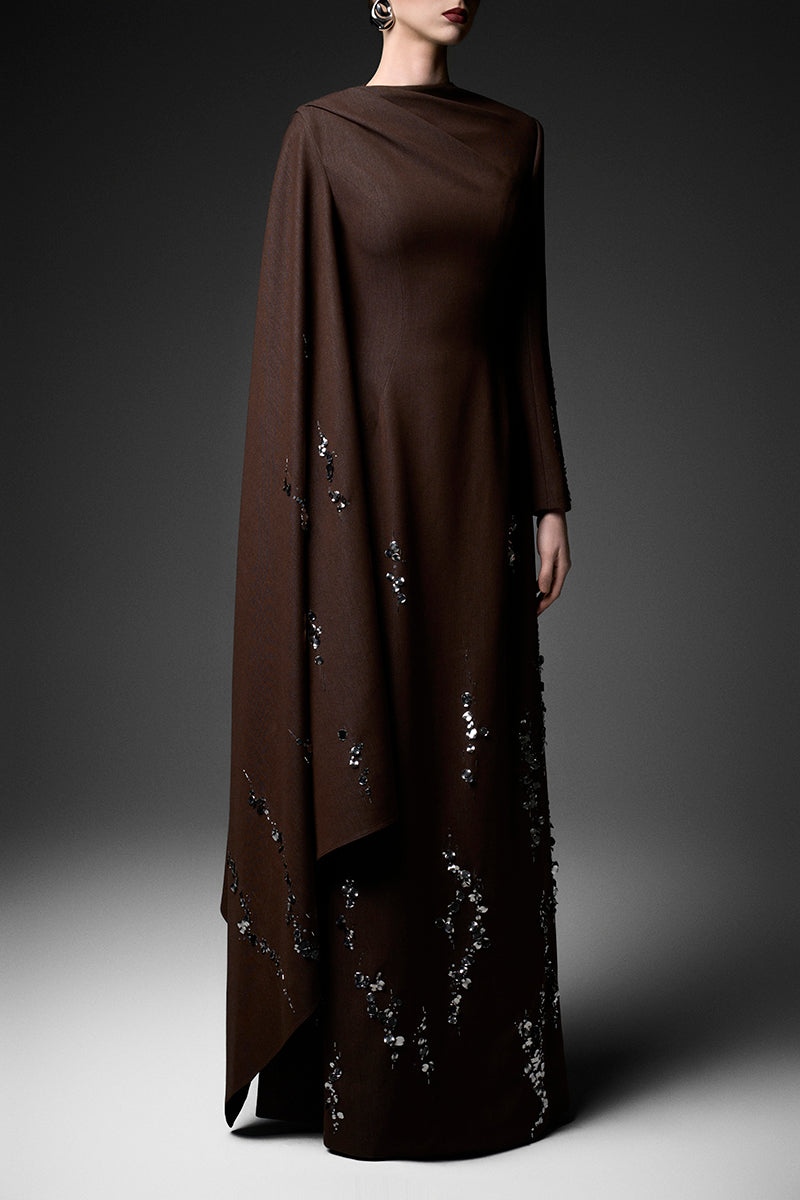 Elegant deep tone embroidered gown by GVLUX with intricate embroidery, flowing fabric, and stylish design for formal occasions.