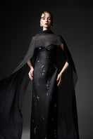 Black Cape Neck column gown by GVLUX featuring sleek fabric and elegant drape, perfect for formal occasions.