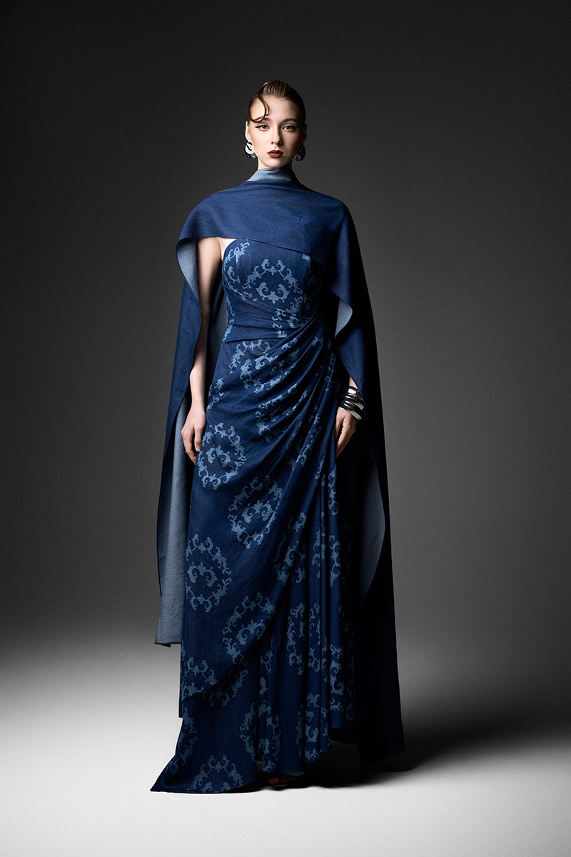 Navy cape neck gown by GVLUX featuring elegant design and flowing fabric, perfect for formal occasions.