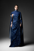 Navy cape neck gown by GVLUX featuring elegant design and flowing fabric, perfect for formal occasions.