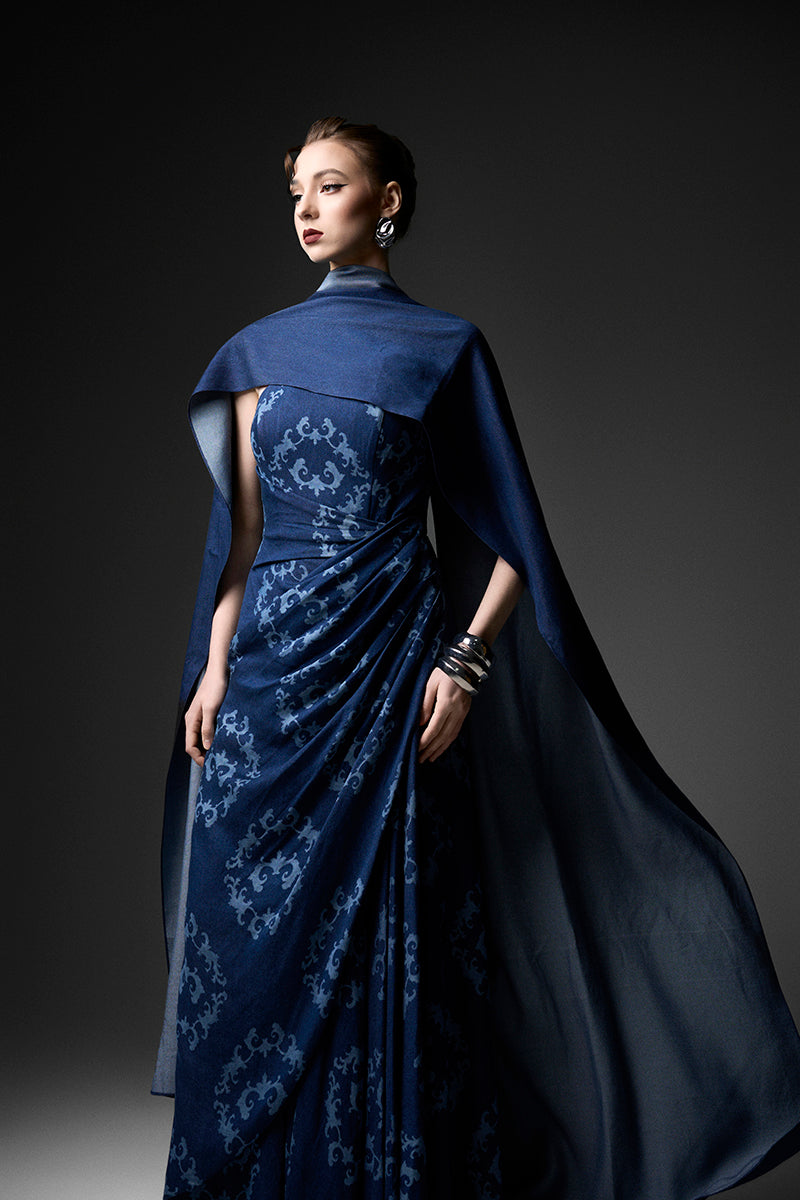 Navy cape neck gown by GVLUX featuring a flowing design and elegant style, perfect for formal occasions.