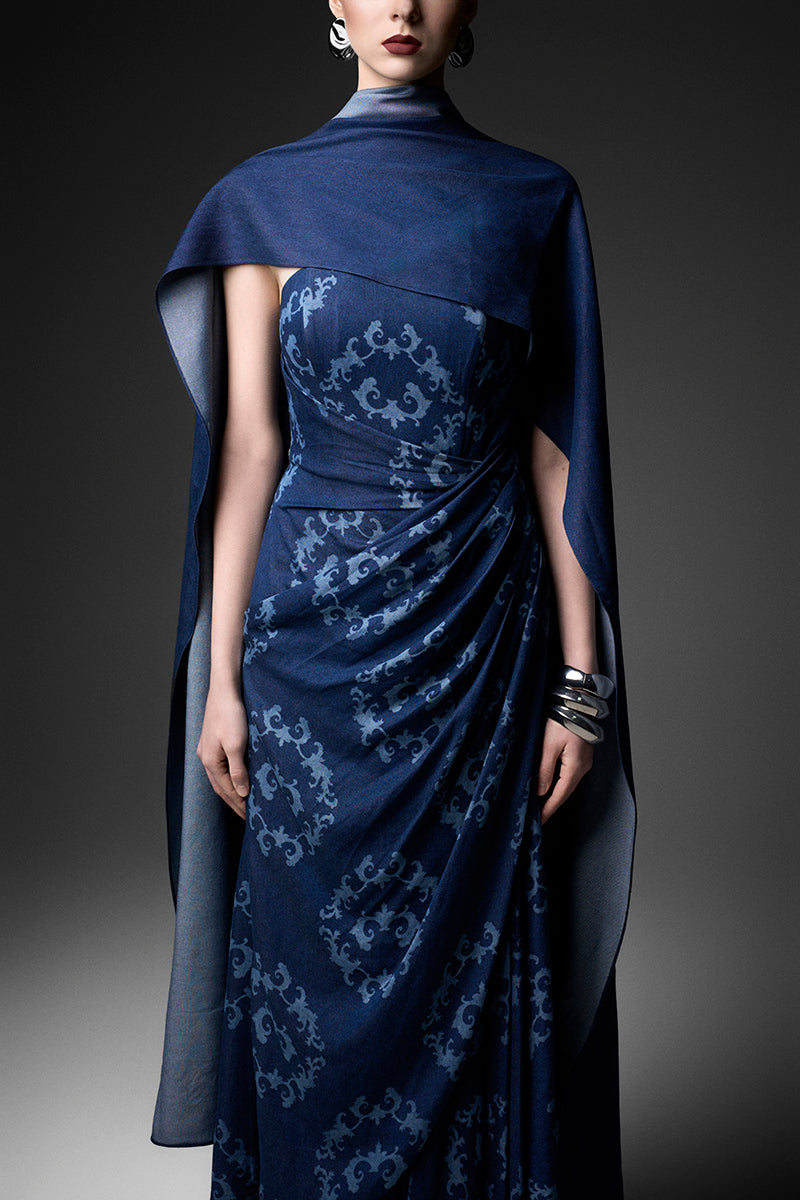 Navy cape neck gown by GVLUX featuring elegant flowing fabric and a sophisticated design, perfect for formal occasions.
