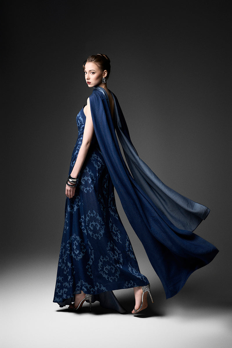 Navy cape neck gown by GVLUX featuring elegant flowing fabric and sophisticated design, perfect for formal occasions.