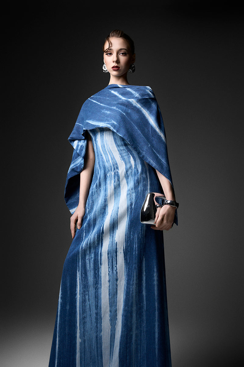 Elegant navy water ripples cape neck gown by GVLUX with flowing fabric and intricate detailing, perfect for formal occasions.