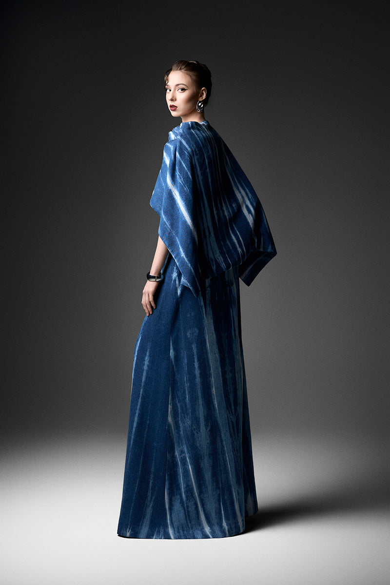 Elegant water ripples cape neck gown by GVLUX featuring flowy fabric and intricate design details.