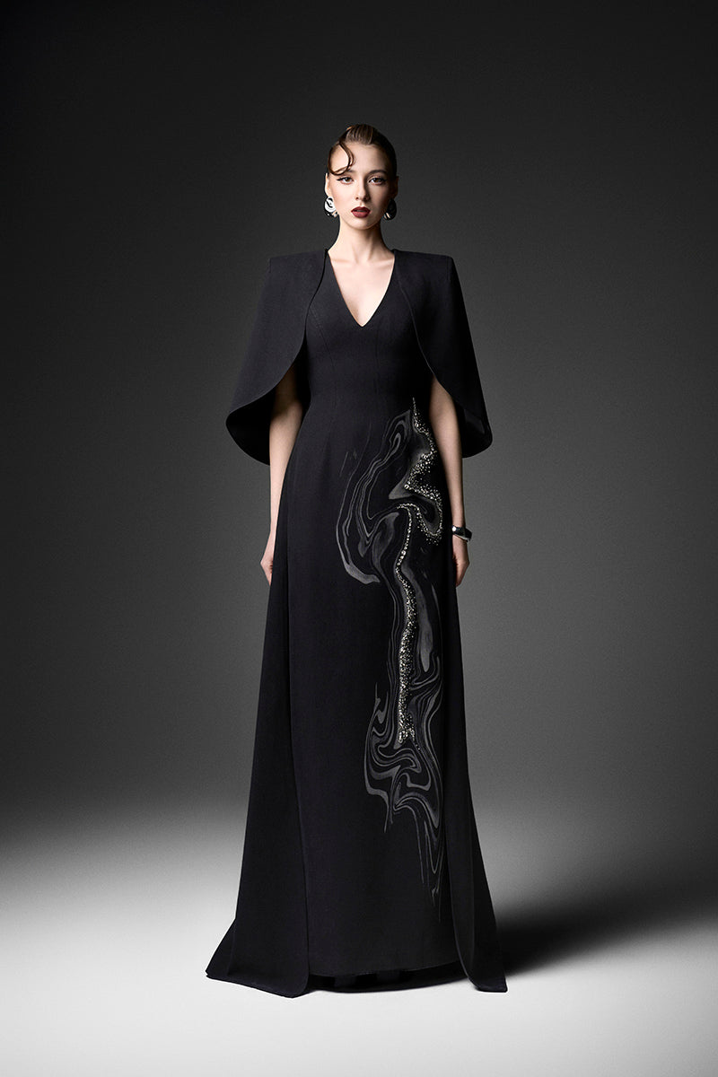 Gown by GVLUX Midnight Fireworks V-neck gown in elegant dark fabric, featuring a flowing silhouette and subtle detailing.