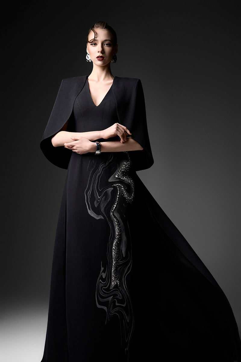 Elegant midnight firework V-neck gown by GVLUX, featuring a flowing silhouette and intricate design details.