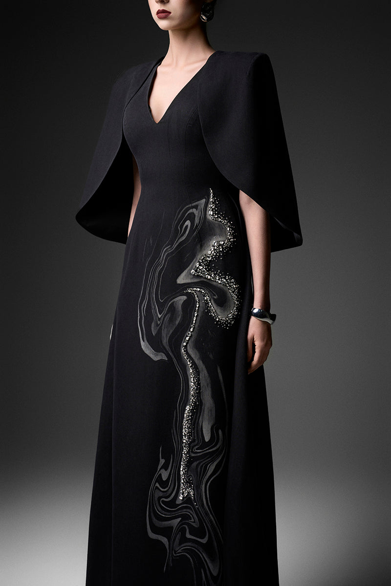 Elegant midnight firework pattern V-neck gown by GVLUX, flowing fabric with intricate design for formal occasions.