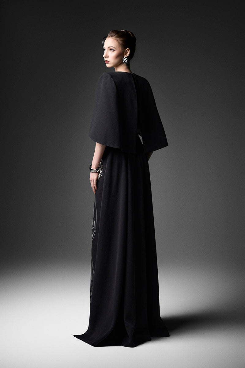 Elegant midnight blue V-neck gown by GVLUX, featuring flowing fabric and stylish design for formal occasions.