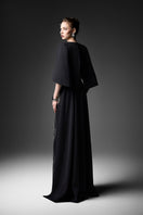 Elegant midnight blue V-neck gown by GVLUX, featuring flowing fabric and stylish design for formal occasions.