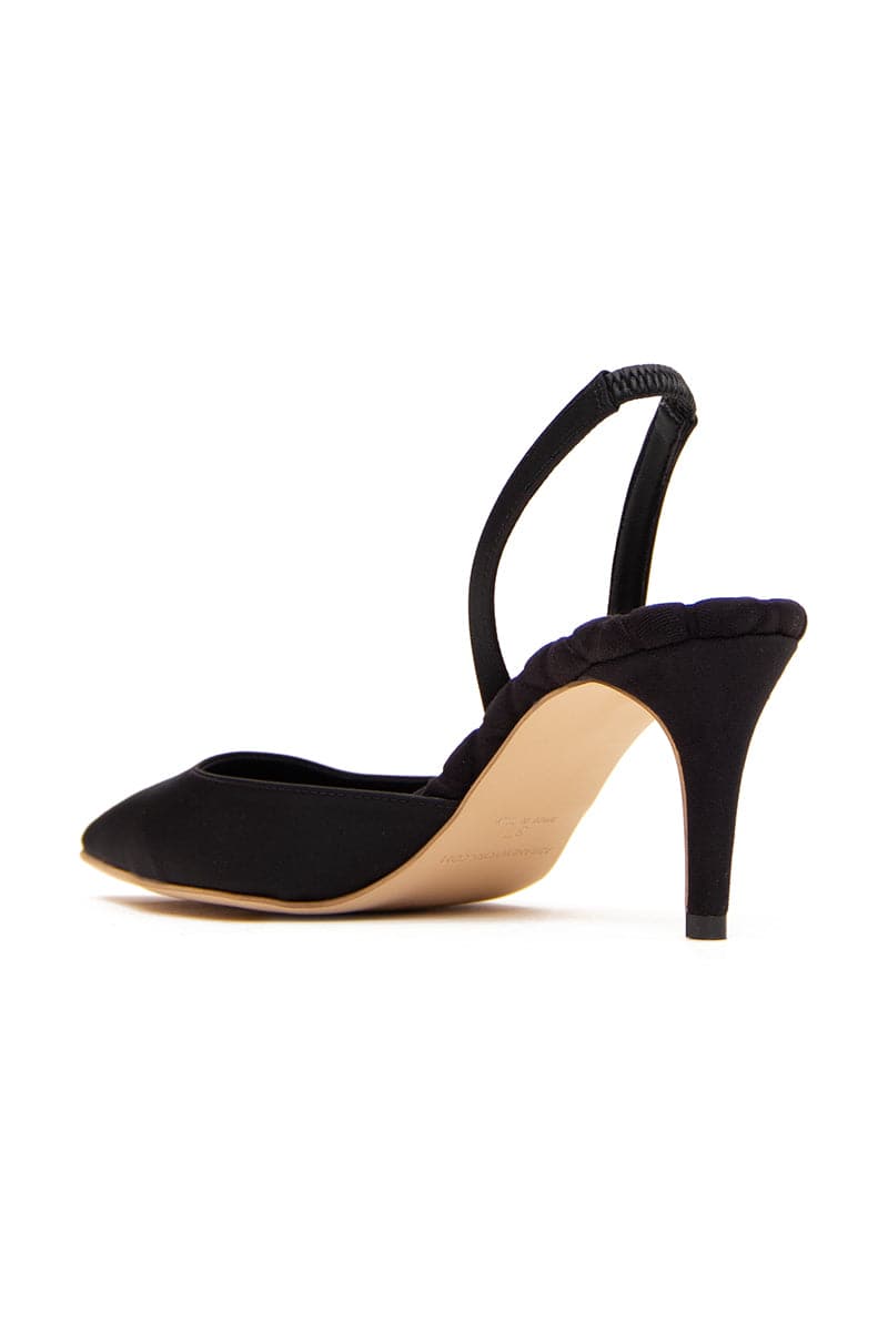 A pair of elegant black satin Gabriella slingback heels by AERA, featuring a sleek design and pointed toe on a plain background.