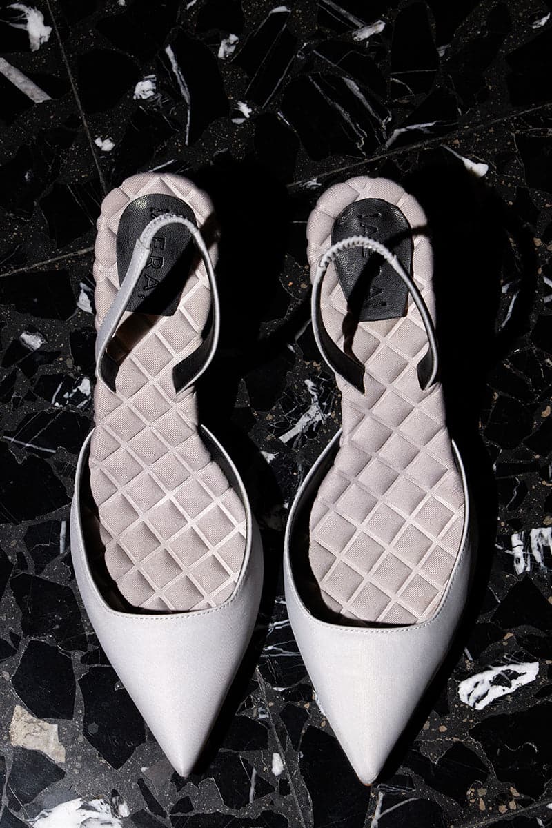 A pair of AERA Gabriella gray satin slingback heels with pointed toes and slender stiletto heels, stylish and elegant.