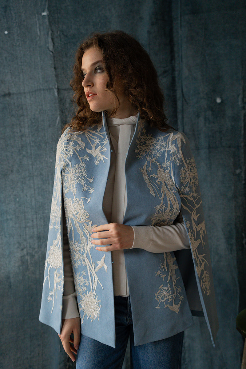 Nadya Shah Gabriel in Denim Dream Cape, stylish denim jacket with a flowing cape design, showcased in a fashion photoshoot.