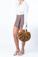 Beige Mara Brazil Gaia top handle bag with sleek design and structured shape, featuring a comfortable top handle.