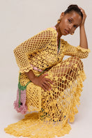 Yellow handmade knit midi skirt by Andreeva featuring a flowing silhouette and intricate stitch details.