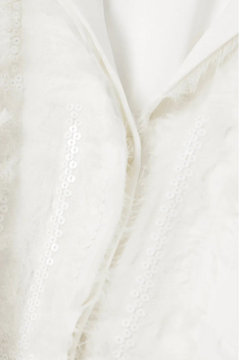 White silk chiffon blouse with embellishments from SemSem, featuring delicate fabric and intricate decorative details.