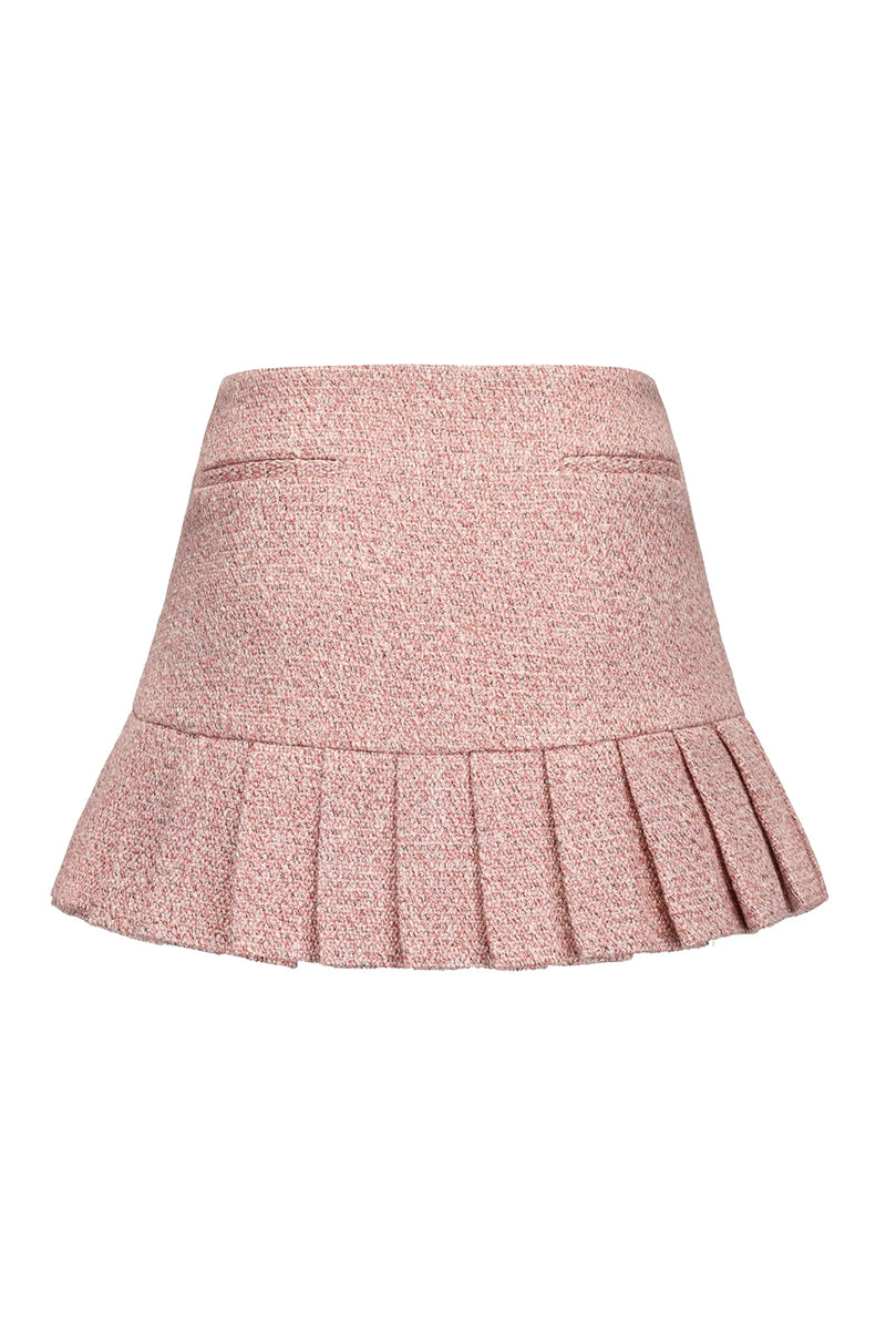 Nana Jacqueline pink GIA mini skirt with pleated design, shown from the back in this stylish fashion image.