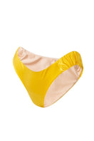 Yellow glossy bikini bottom by Suncillo, Gina Sicily style, with smooth fabric and a modern fit, shown on a model.