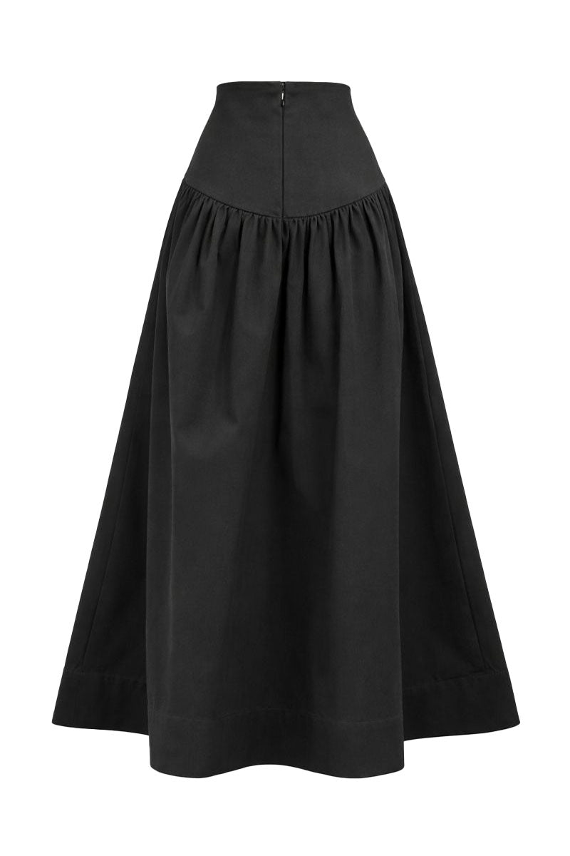 Black Ginevra maxi skirt by ANA + MARIA, flowing fabric with a stylish silhouette, displayed in a ghost photo style.