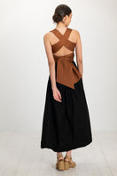 Black Ginevra maxi skirt by ANA + MARIA, flowing fabric with a high waist and elegant design, shown in a full-length view.