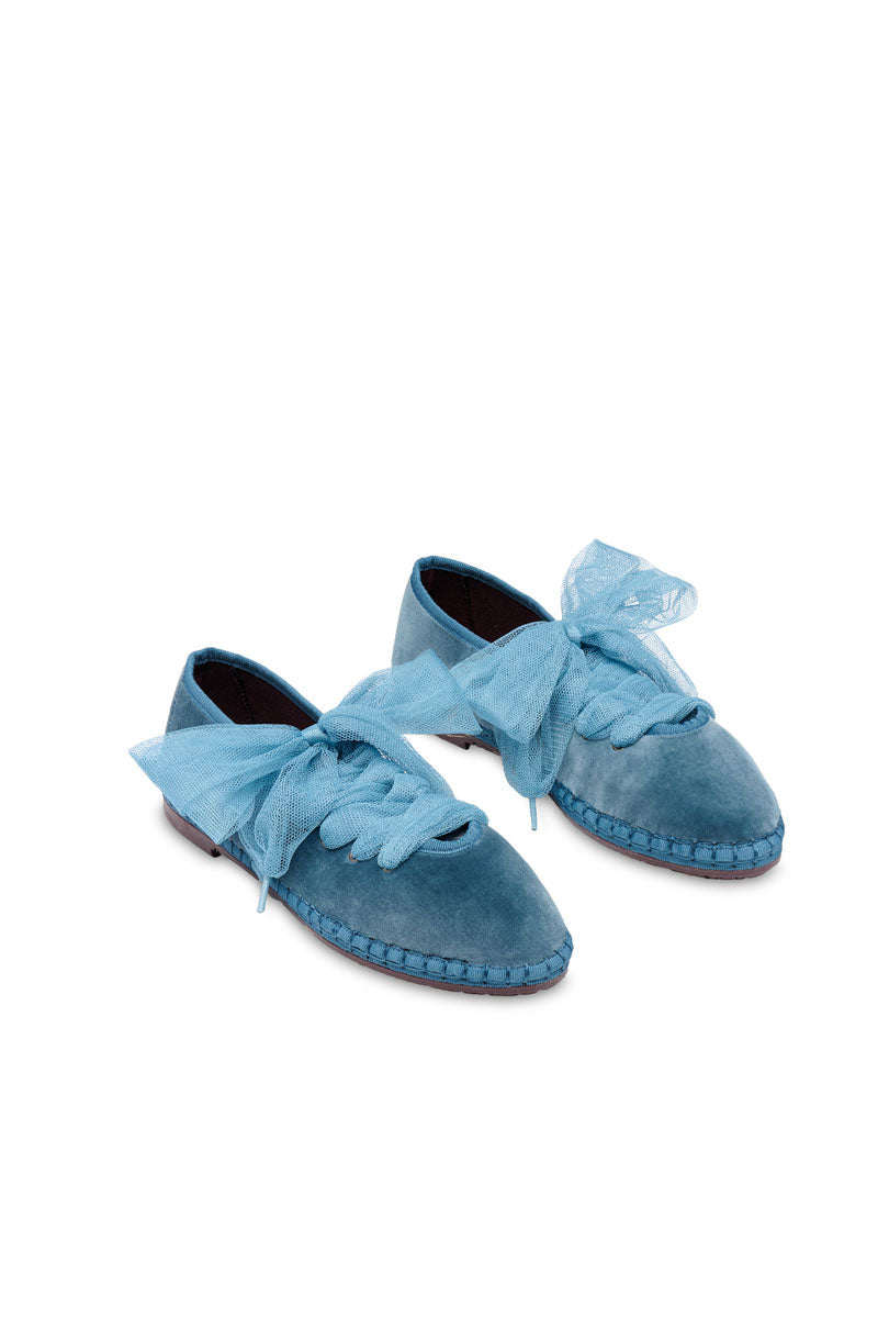 Flabelus Ginevra Blue flats with rounded toe and sleek design, shown on a model's feet on a neutral background.