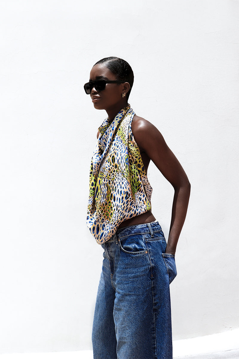 Amel Batita GIO MOUSSARD silk scarf featuring vibrant patterns, shown draped elegantly in a close-up image.