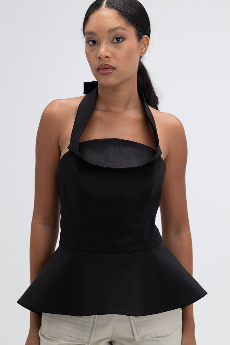 Black Giselle top by ANA + MARIA, featuring a stylish design, displayed on a mannequin with a close-up of the fabric texture.