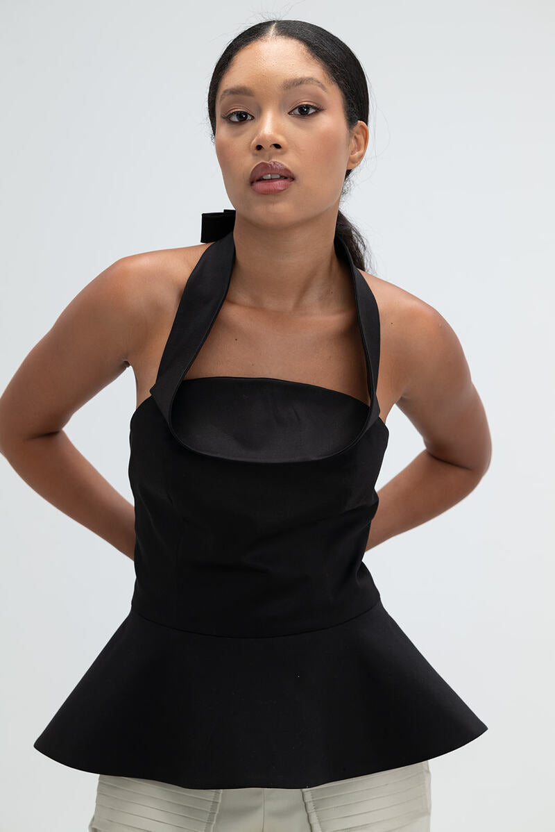 Black Giselle top by Ana + Maria, showcasing the stylish sleeveless design and fitted silhouette in a web size 2 image.