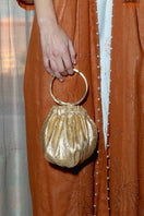 Gold Alice wristlet by Sarah's Bag featuring a sleek gold top handle design and compact style for elegant carrying.