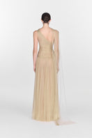 Elegant gold draped gown by Montsand, featuring flowing fabric and sophisticated design, perfect for formal occasions.