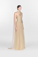 Elegant gold draped gown by Montsand featuring flowing fabric and a sophisticated maxi design.