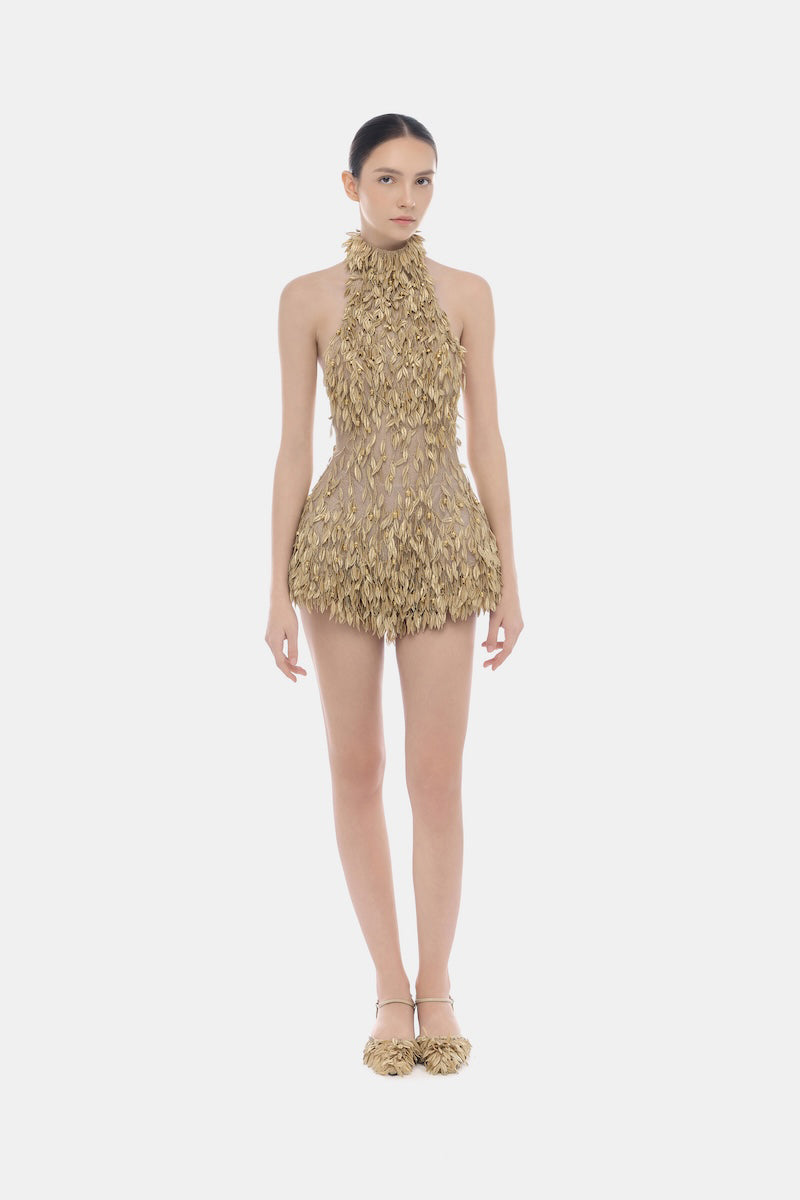 Gold high neck jumpsuit by Montsand, featuring a sleek design and fitted silhouette, displayed on a mannequin.