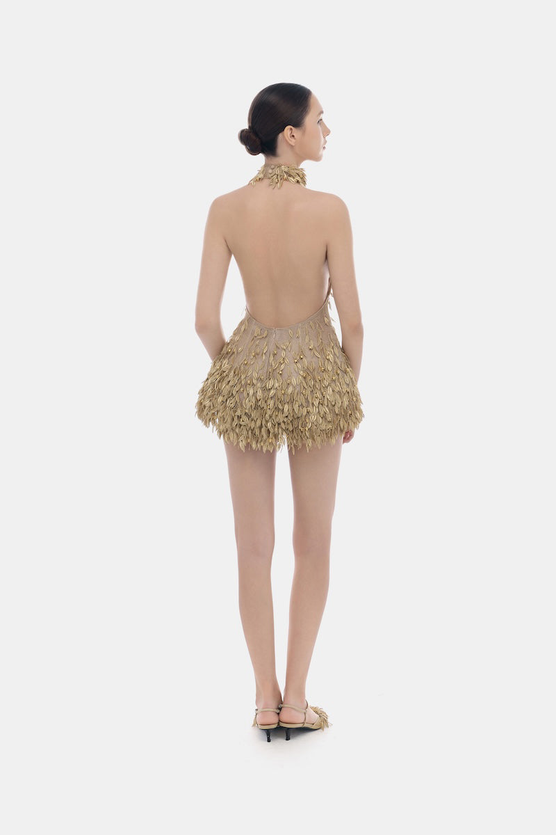 Gold high neck jumpsuit by Montsand, showing the elegant fitted design and sleeveless style on a model.