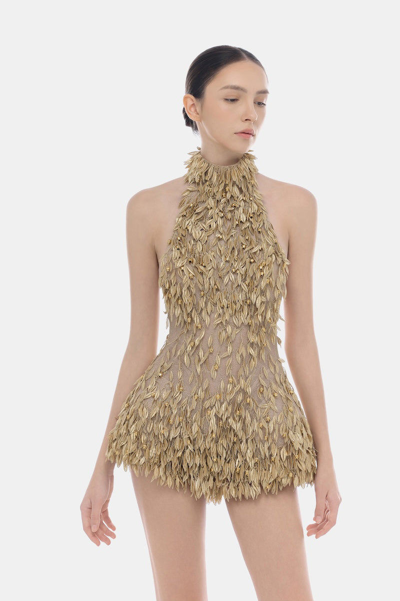 Gold high neck jumpsuit by Montsand featuring a sleek fit and elegant design, shown on a model in this stylish product image.