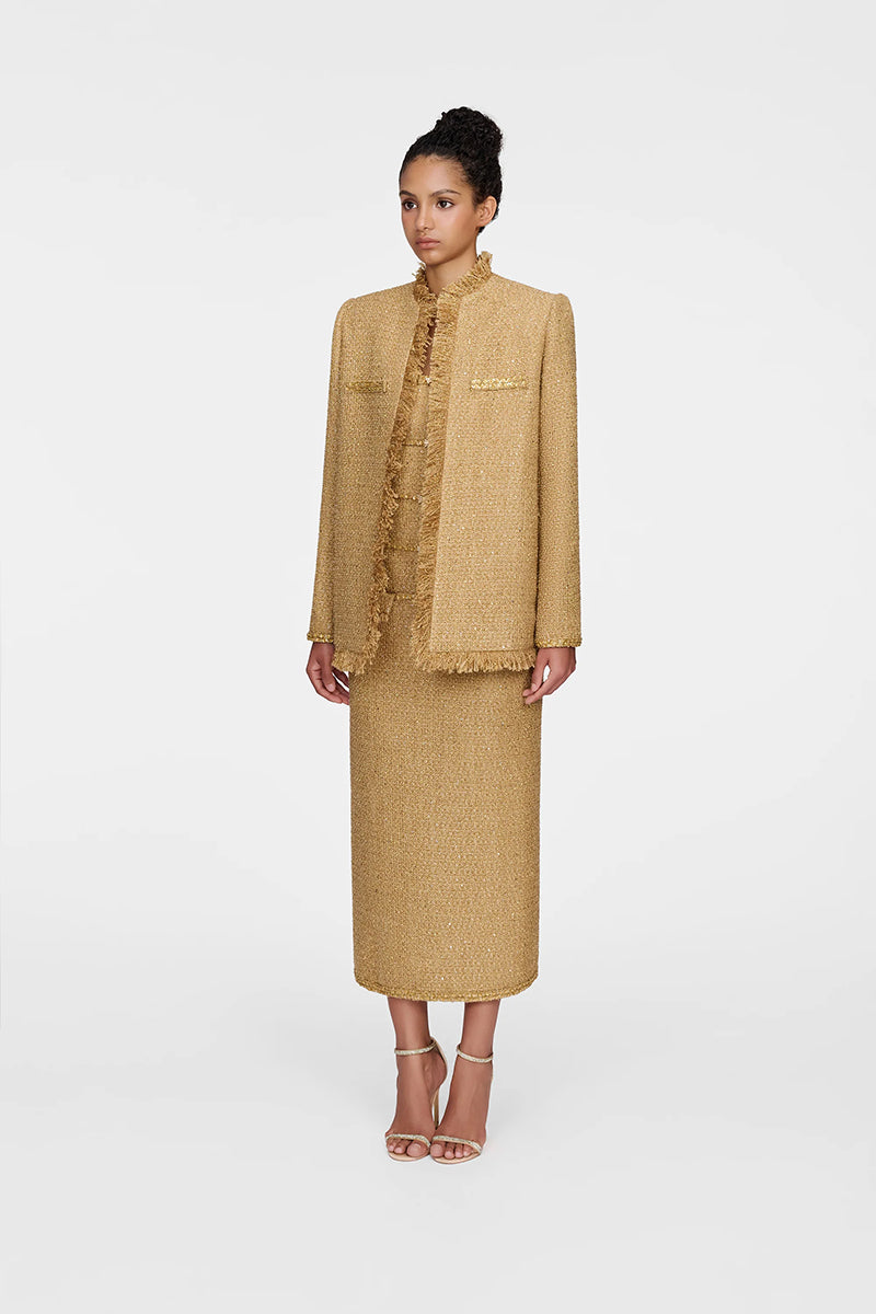 Montsand Gold Julia Jacket displayed on a hanger, showcasing its stylish gold-colored jacket with a sleek design and tailored fit.