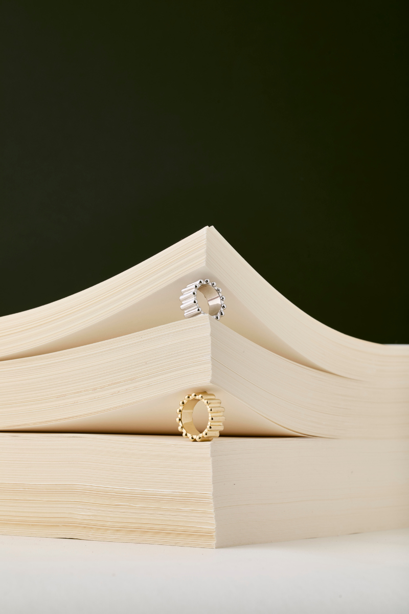 Golden Crono ring by Maria Frering featuring a sleek gold band and modern design, displayed on a neutral background.