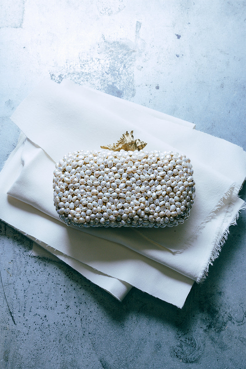 Sarah's Bag Golden Murex Loulou white clutch with intricate gold detailing and elegant design, perfect for evening events.