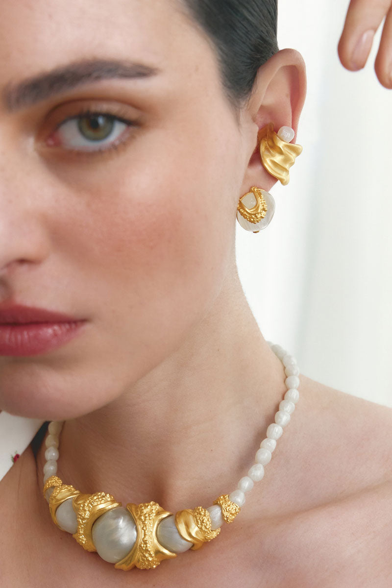 Gold gravity ear cuff earrings by Jude Benhalim featuring a sleek, modern design for a stylish ear embellishment.