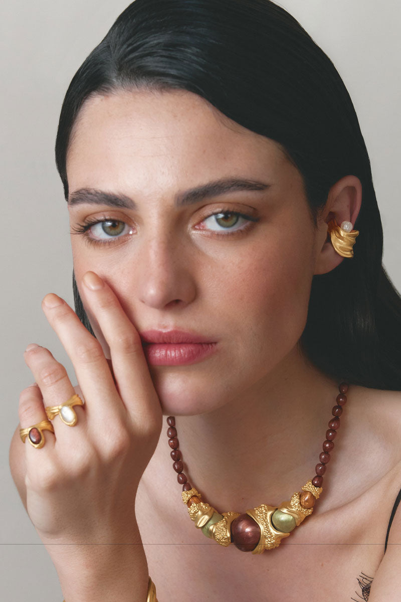Gold Gravity Ear Cuff earrings by Jude Benhalim, featuring a sleek, modern design with a smooth curved shape.