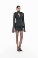 Gray single-breasted blazer by Montsand, displayed on a hanger with a matching skirt, stylish and tailored for professional wear.