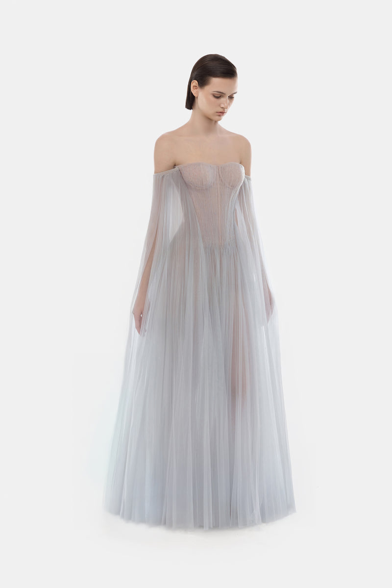 Grey tulle off-shoulder maxi dress by Montsand with a flowy silhouette and elegant design, perfect for formal or casual occasions.