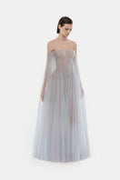 Grey tulle off-shoulder gown by Montsand, featuring a flowing maxi design with elegant off-shoulder neckline and delicate fabric.