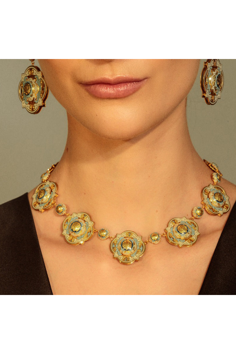 Álvaro Ávila Guardian pendant necklace featuring a blue pendant on a silver chain, styled with casual wear.