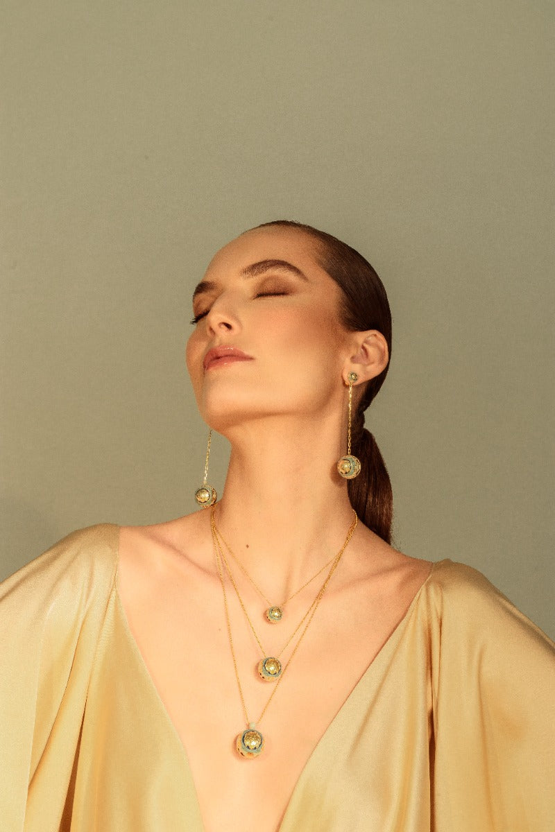 Álvaro Ávila Guardian Sphere Necklace featuring a sleek, blue pendant on a delicate chain, showcasing modern jewelry design.